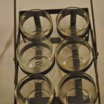 6 glazen waxinelichthouders in metalen frame